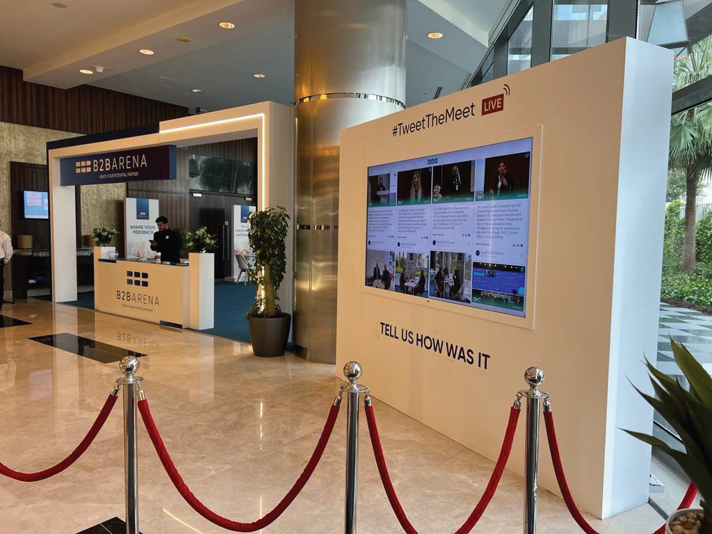 Registration desk and live tweet wall at a conference